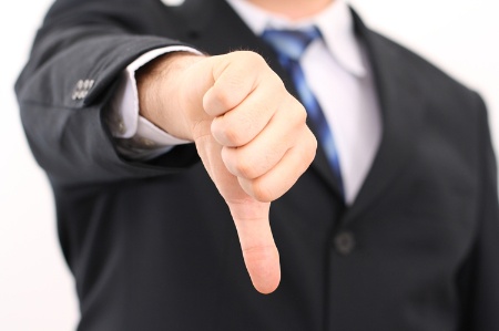 Businessman with thumb down