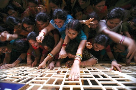 Crowd of women holding onto bars