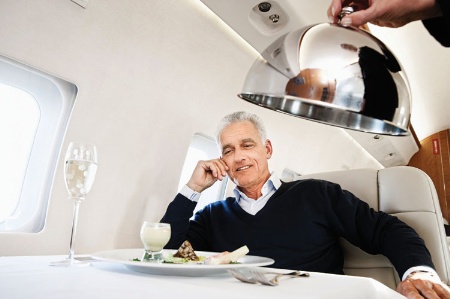 Businessman served food on airplane