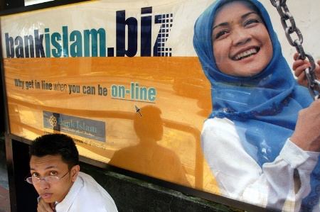 Man with BankIslam.biz sign