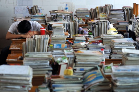 Chinese student surrounded by books