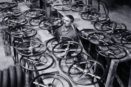 Man in workshop working on car steering wheels