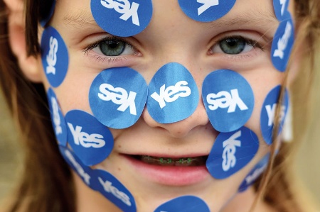 A girl wearing yes stickers on her face
