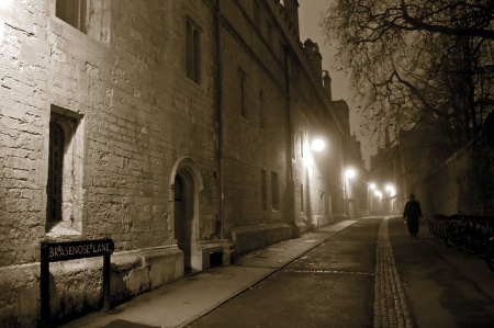 Man walking down Brasenose Lane, Oxford, at-night