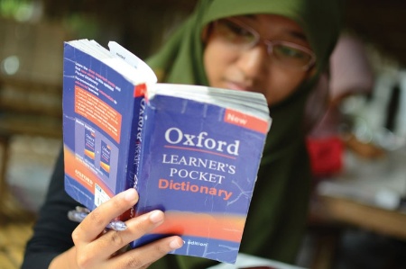 Indonesian woman reading English dictionary