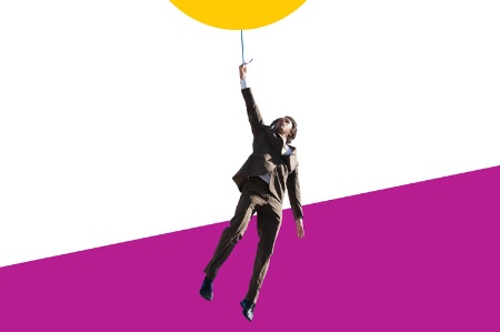 Businessman hanging from balloon