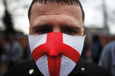A man wearing a mask with the England flag on it