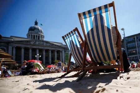 People sitting in deckchairs on man made beach