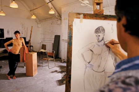 Male model being drawn by an artist