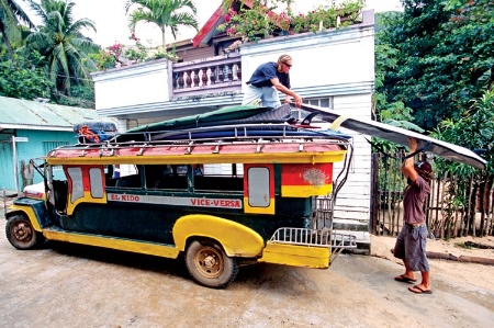 Surfboards transported on the top of a bus