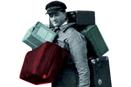 Hotel porter laden with luggage