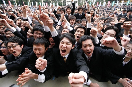 Crowd of male students cheering