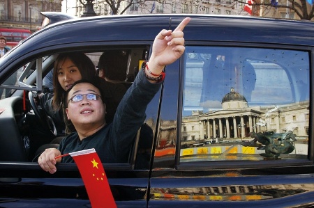 Tourists in London taxi at Trafalgar Square
