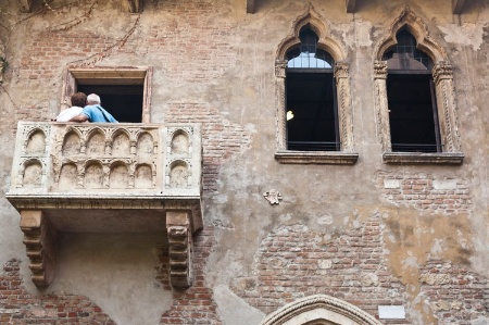 People posing for photograph on Italian balcony